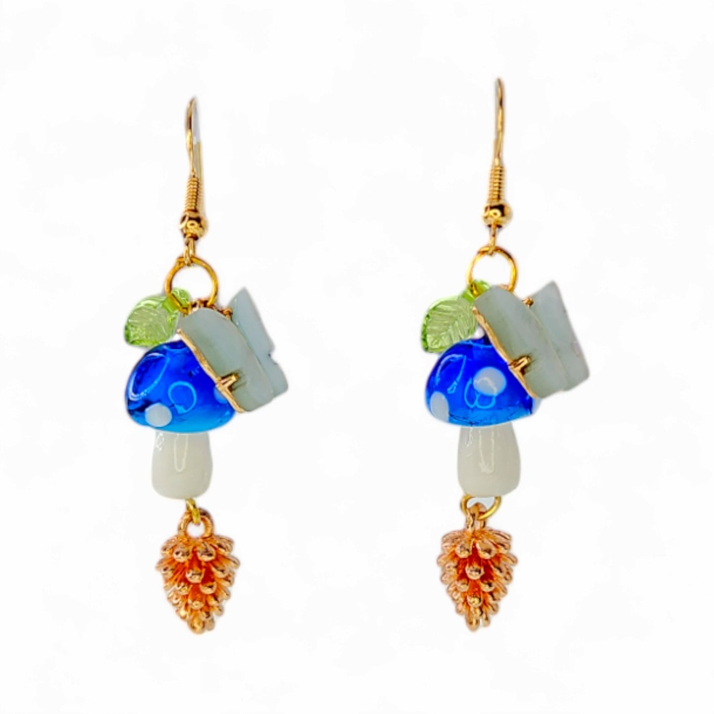 Woodland Dreams dangle earrings with whimsical blue mushrooms and golden pinecone charms