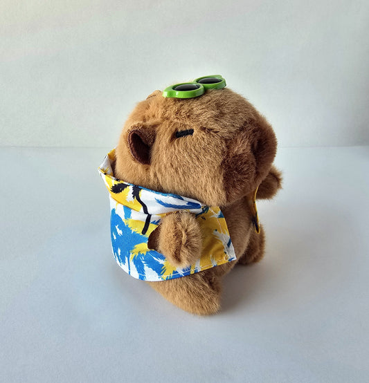 Brown capybara plush keychain wearing tropical shirt with green sunglasses, angled view