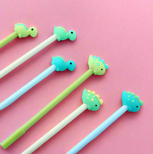 Assorted dinosaur pen toppers arranged on a pink background, flatlay