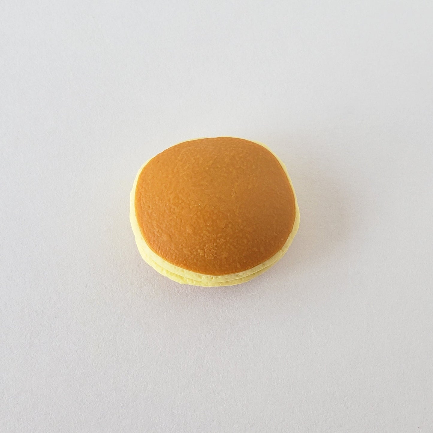 Flatlay of Iwako Dorayaki Pancake Eraser showing its realistic pancake layers and smooth vinyl texture on a white surface