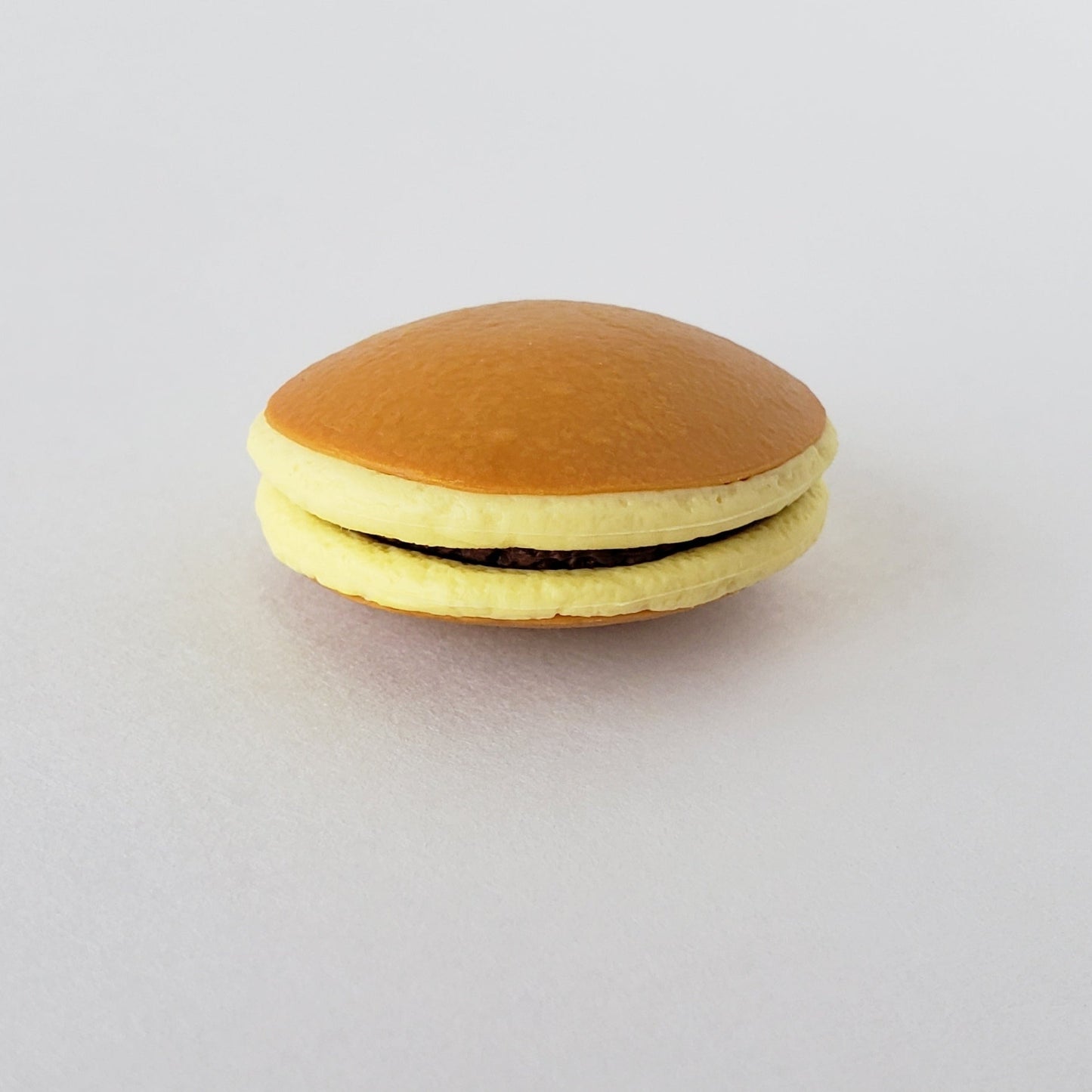 Closeup front view of Iwako Dorayaki Pancake Eraser highlighting the detailed filling and rounded edges