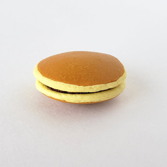 Closeup side view of Iwako Dorayaki Pancake Eraser showcasing its soft vinyl thickness and lifelike pancake profile