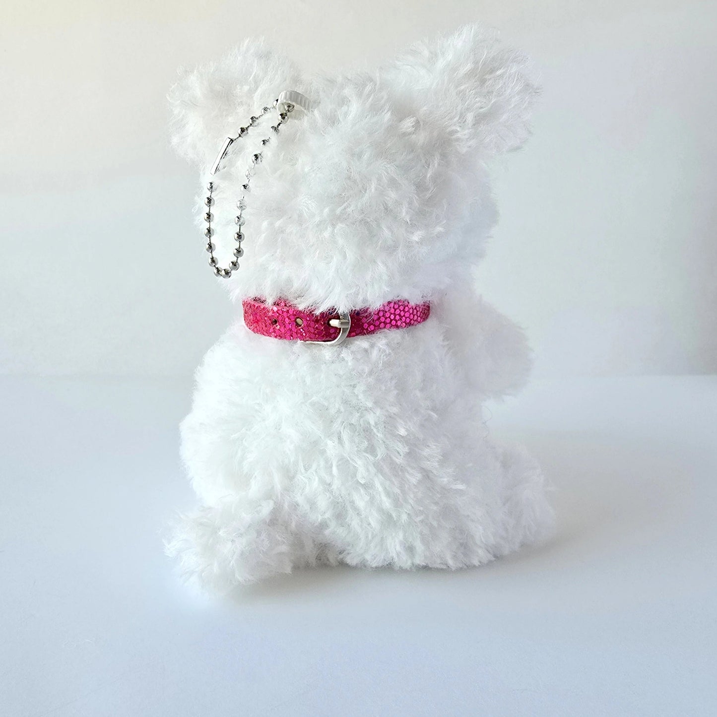 Back of plush keychain showing collar and chain attachment