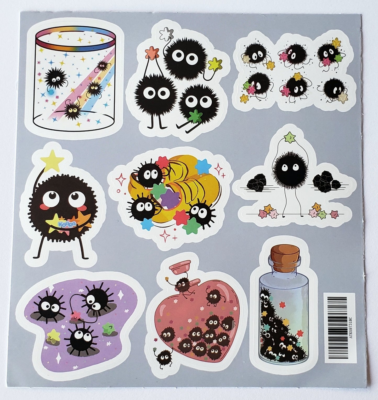 Flatlay of soot sprites inside a mason jar with star accents on a white background