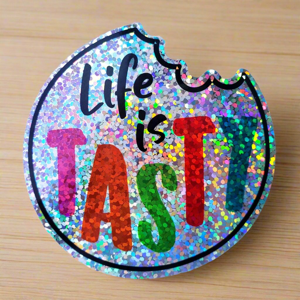 Confetti Kitty: Colorful, glittery circular design with ‘Life is TASTY’ text