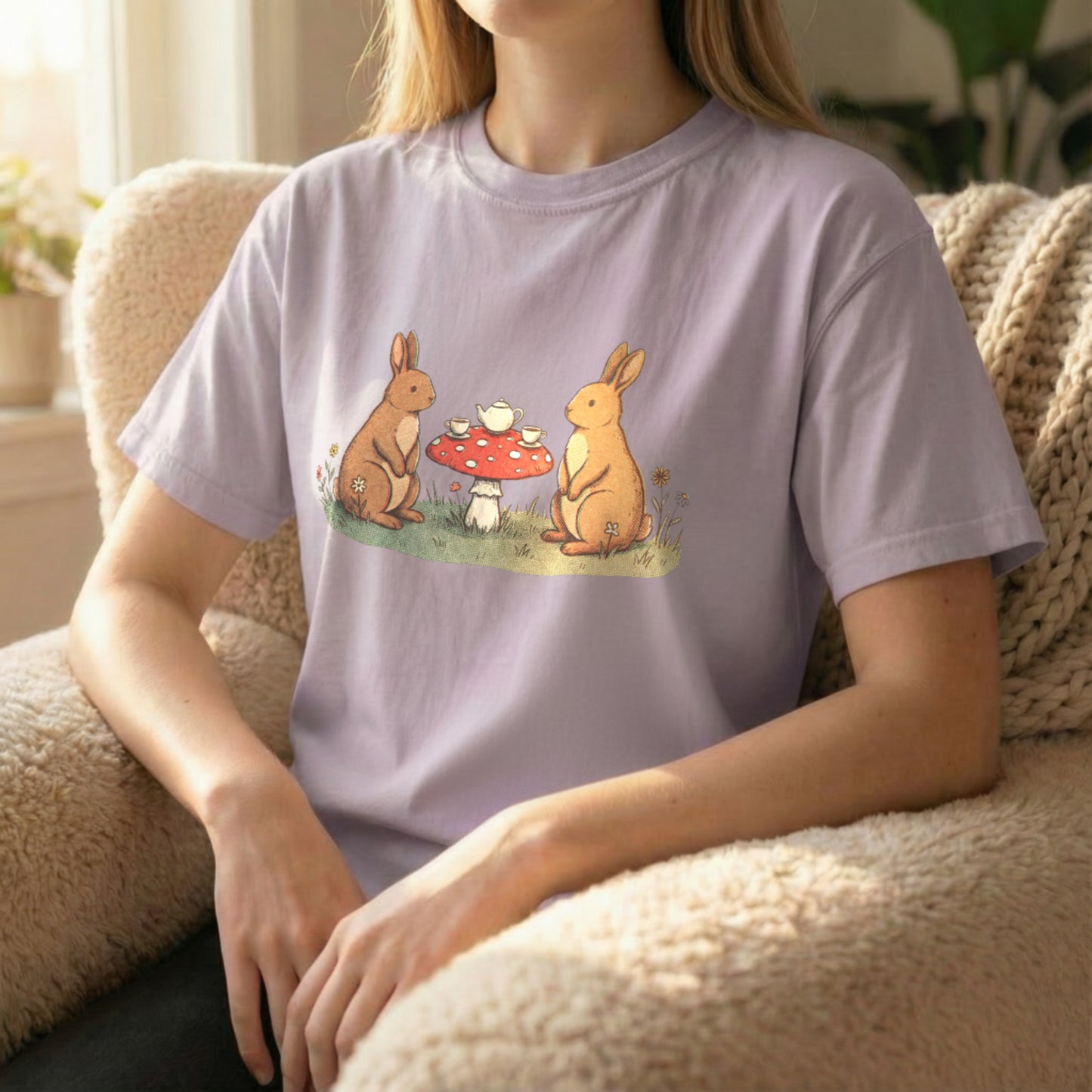 Bunny Picnic Tee worn seated on orchid shirt with cozy storybook bunny picnic design