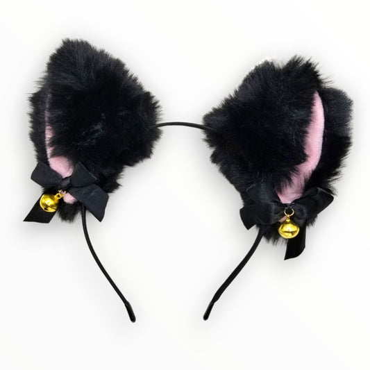 Black fluffy cat ears headband with pink inner lining, bow, and bell on white background