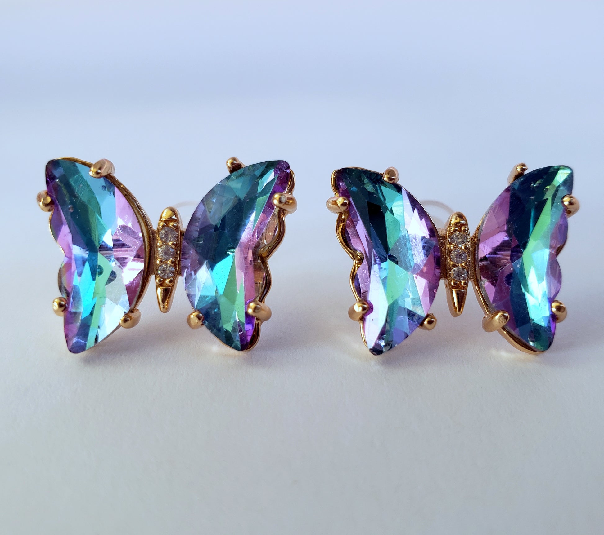 Crystal butterfly stud earrings in lilac ice blue on white background
