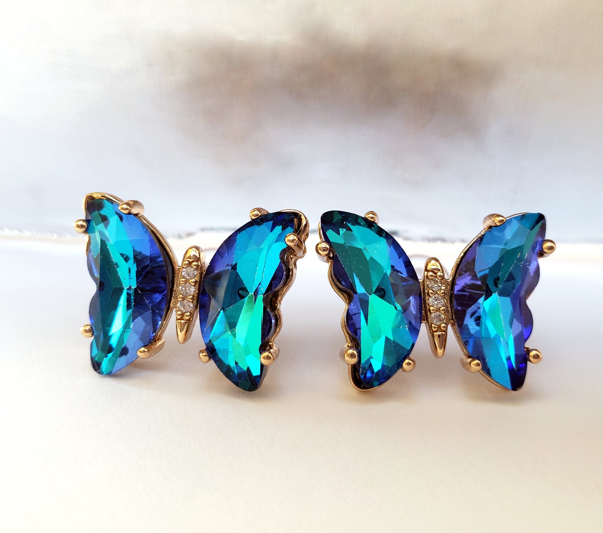 Crystal butterfly stud earrings in ultramarine on white background