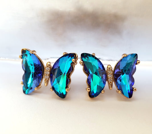 Crystal butterfly stud earrings in ultramarine on white background