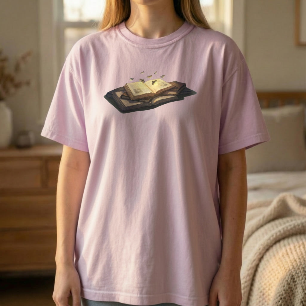 Firefly Book graphic tee worn standing on orchid shirt with warm glowing book illustration