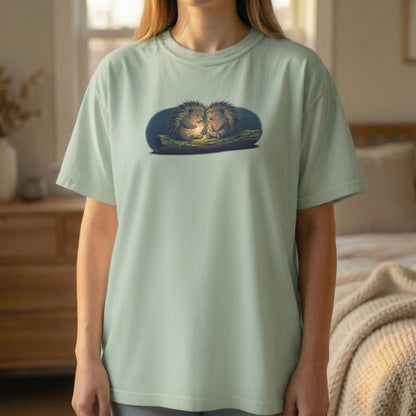 Firefly Hedgehogs tee worn standing on light green shirt with cozy hedgehog illustration and soft glow