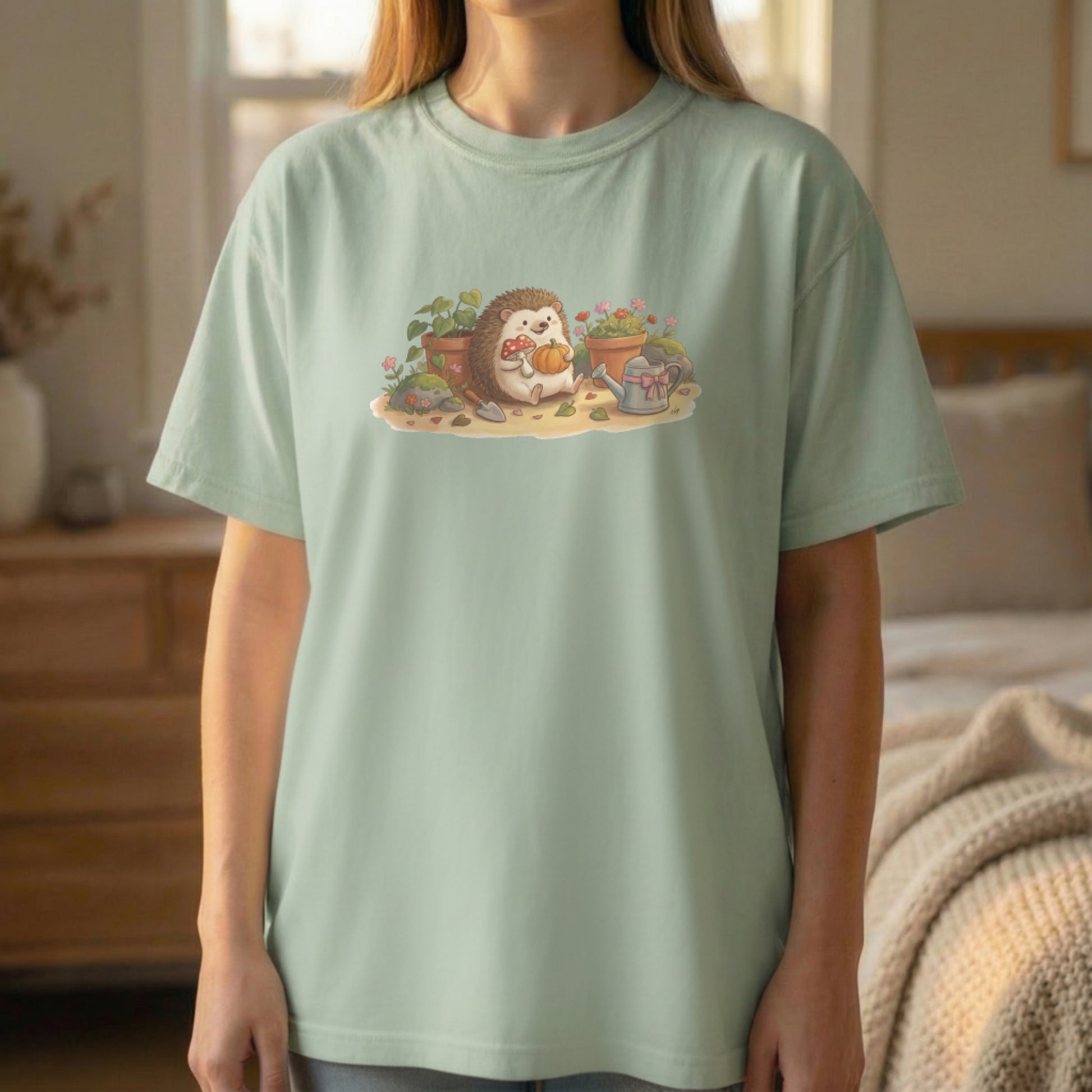Garden Hedgehog tee worn standing on light green shirt with cute hedgehog garden illustration