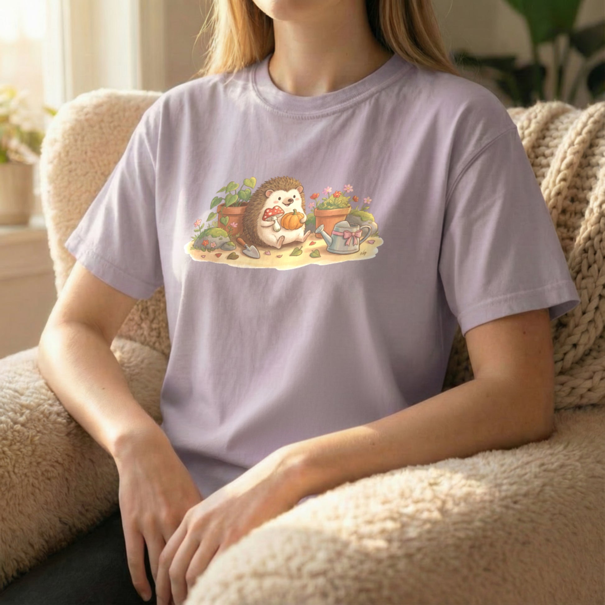 Garden Hedgehog tee worn sitting on orchid shirt with calm garden-themed illustration