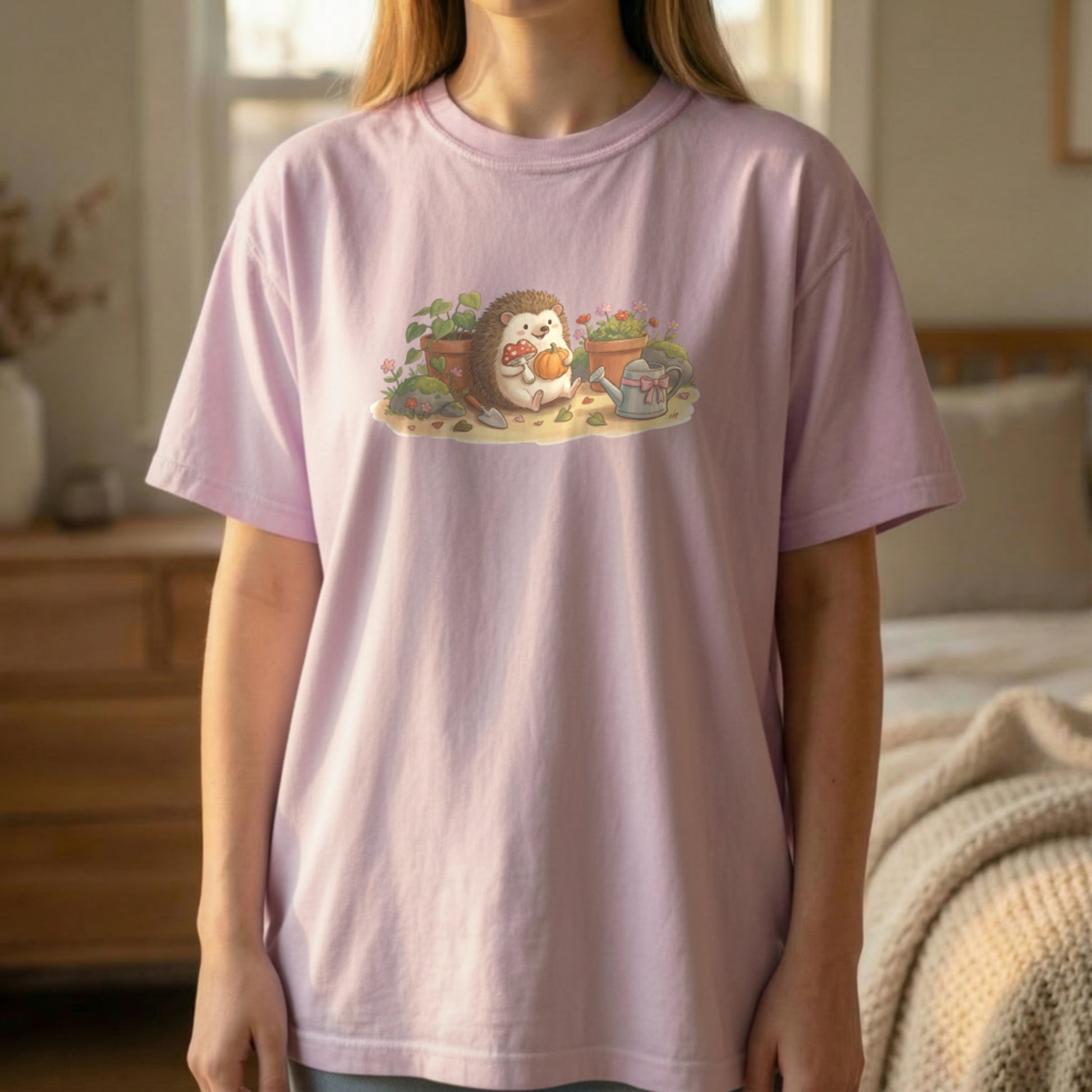 Garden Hedgehog graphic tee worn standing on orchid shirt with soft floral hedgehog artwork