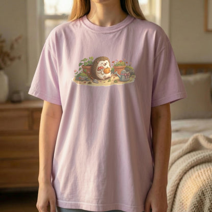 Garden Hedgehog graphic tee worn standing on orchid shirt with soft floral hedgehog artwork