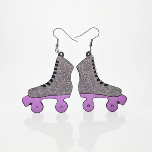 Pair of glitter roller skate dangle earrings with purple wheels on white background