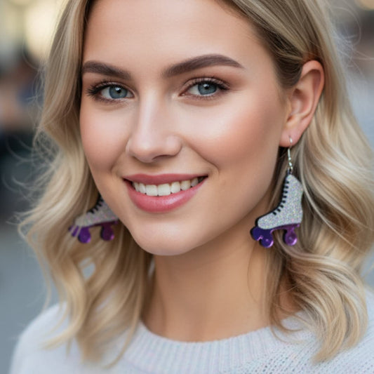 Model wearing glitter roller skate dangle earrings with purple wheels