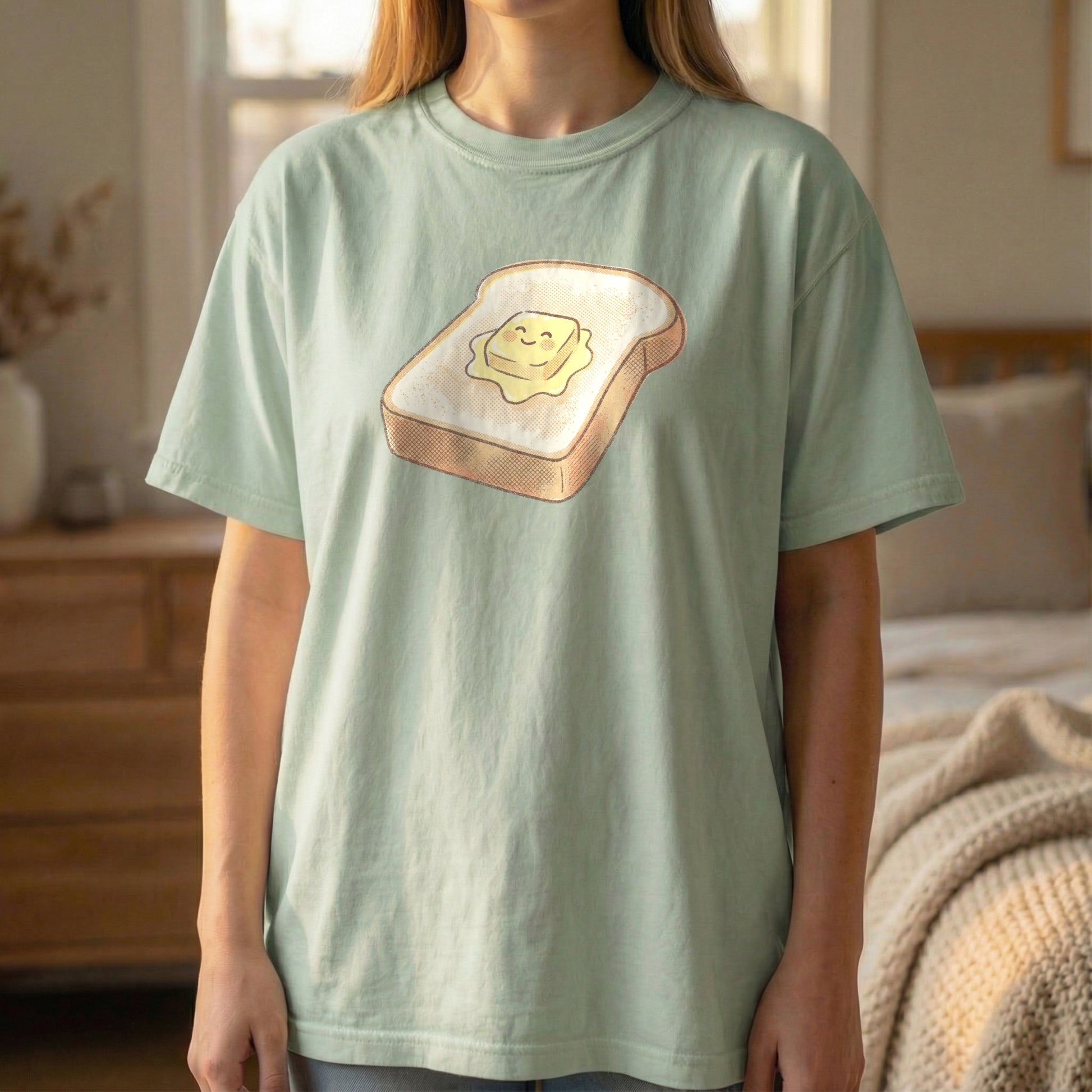 Happy Morning Toast Tee in Light Green, standing pose showing the smiling butter graphic.
