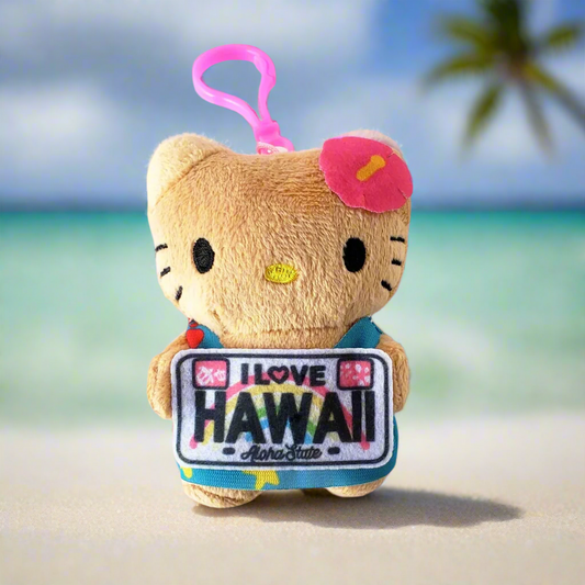Front view of Hawaii Hello Kitty Plush Keychain showing tan plush body, pink hibiscus flower, and “I Love Hawaii” license plate charm on a pink clip