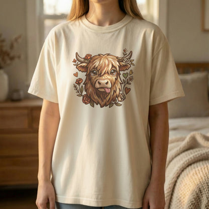 Highland cow graphic tee in ivory shown on model standing indoors