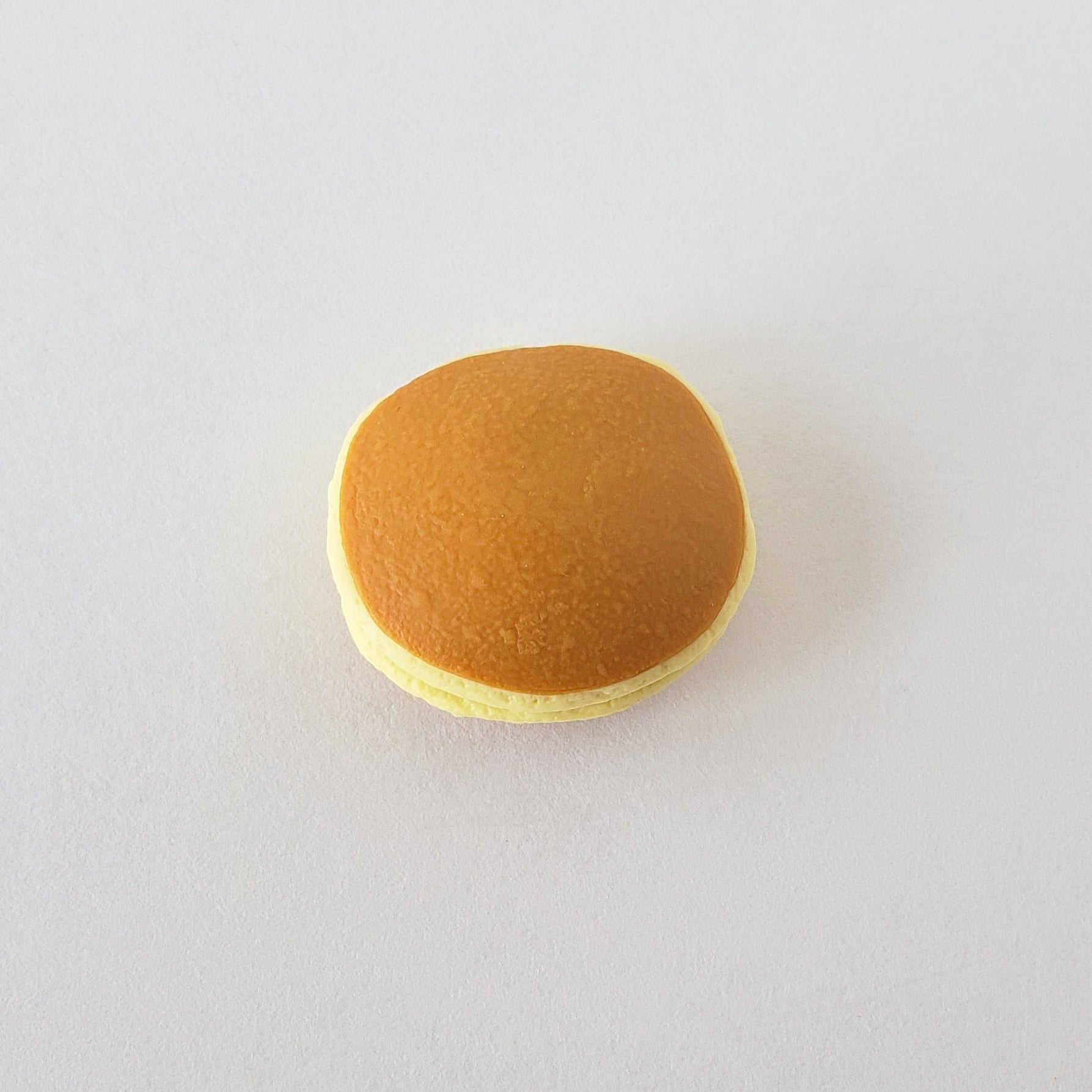 Flatlay of Iwako Dorayaki Pancake Eraser showing its realistic pancake layers and smooth vinyl texture on a white surface