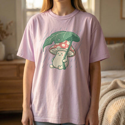 Mockup of a woman standing and wearing an orchid purple t-shirt with a vintage mushroom holding a leaf umbrella design.