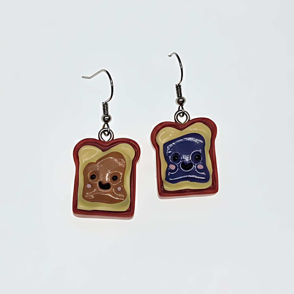 Peanut butter and jelly slice dangle earrings flatlay on white background