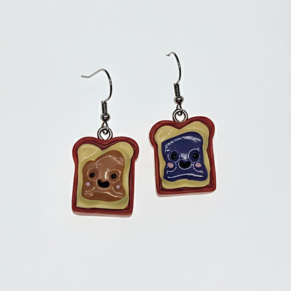 Peanut butter and jelly slice dangle earrings flatlay on white background