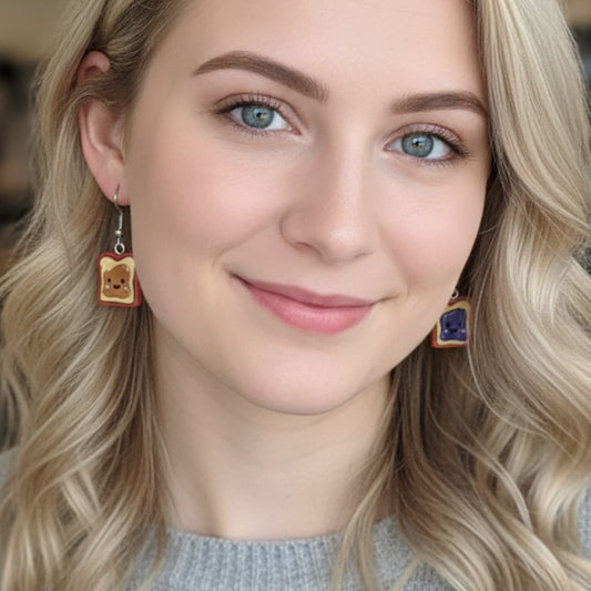 Model wearing peanut butter and jelly slice dangle earrings, cute foodie jewelry