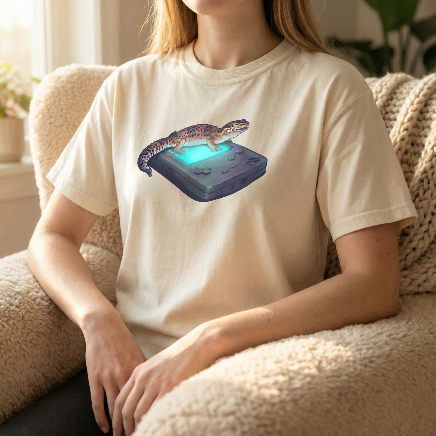 Retro Gecko tee worn sitting on couch on ivory shirt with relaxed retro gaming artwork