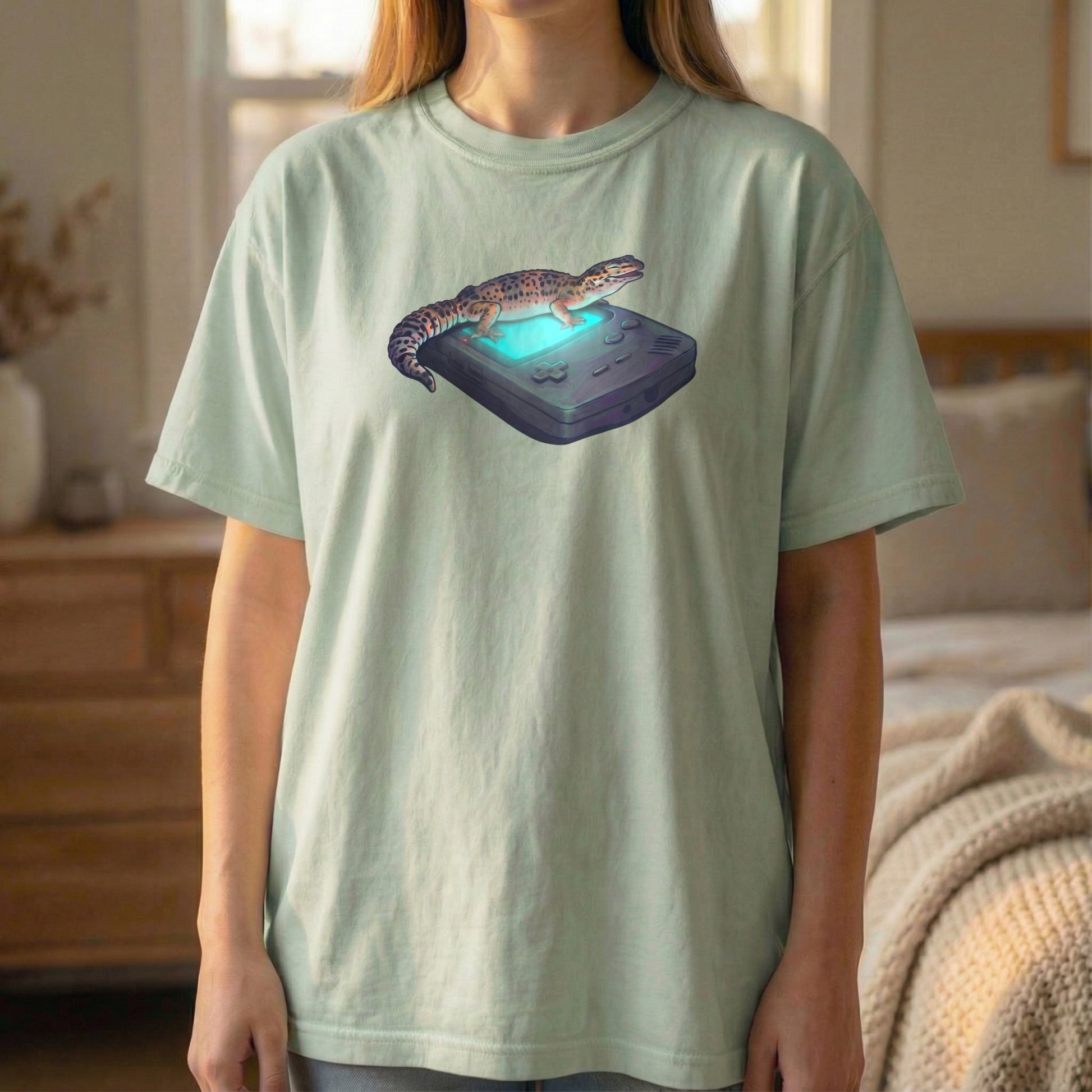 Retro Gecko tee worn standing on light green shirt with cozy retro gaming gecko illustration