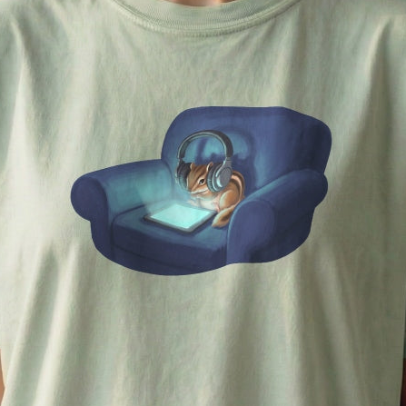 Close-up of Screen Time Chipmunk tee artwork showing cozy chipmunk relaxing in armchair with glowing tablet
