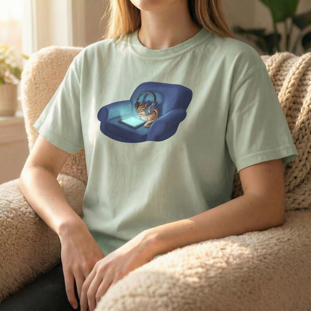 Screen Time Chipmunk tee worn seated on couch, showing relaxed chipmunk illustration with soft glow