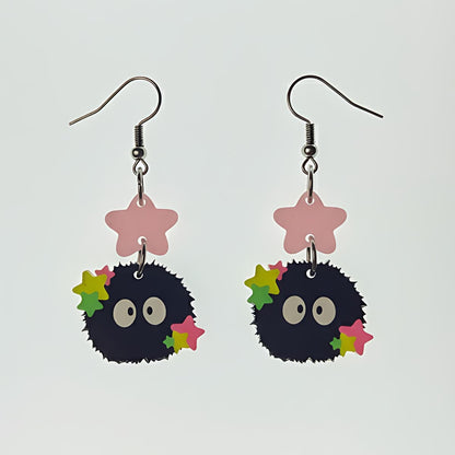 Starry Sprite acrylic earrings with soot sprite design and colorful stars on white background
