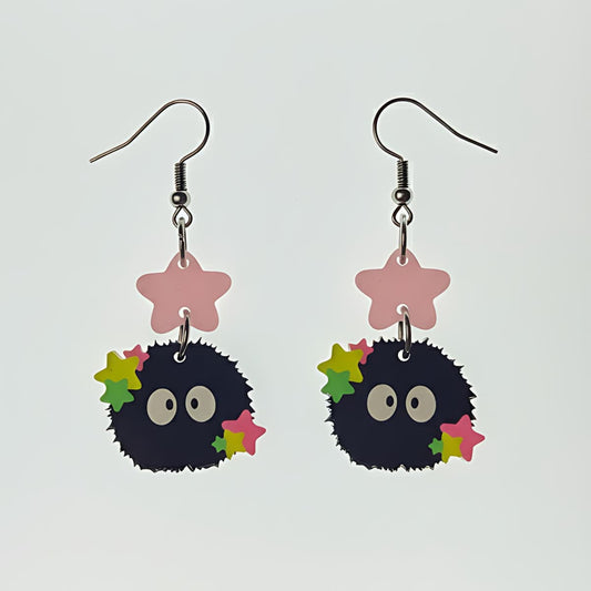 Starry Sprite acrylic earrings with soot sprite design and colorful stars on white background