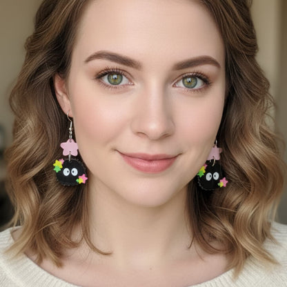 Woman wearing Starry Sprite acrylic earrings with colorful stars