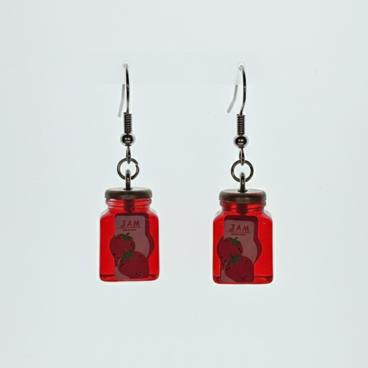 Matching strawberry jam jar dangle earrings on white background; novelty jar style