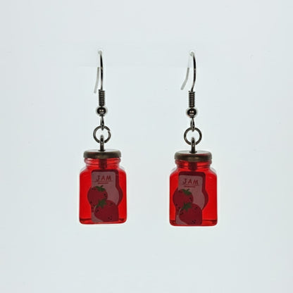 Matching strawberry jam jar dangle earrings on white background; novelty jar style