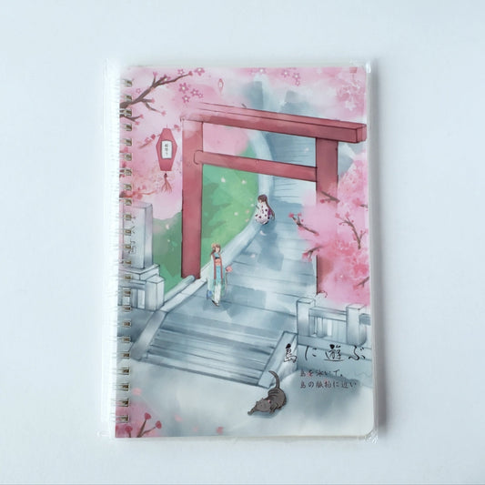 Front view of journal featuring an illustrated red torii gate surrounded by pink cherry blossoms on cover